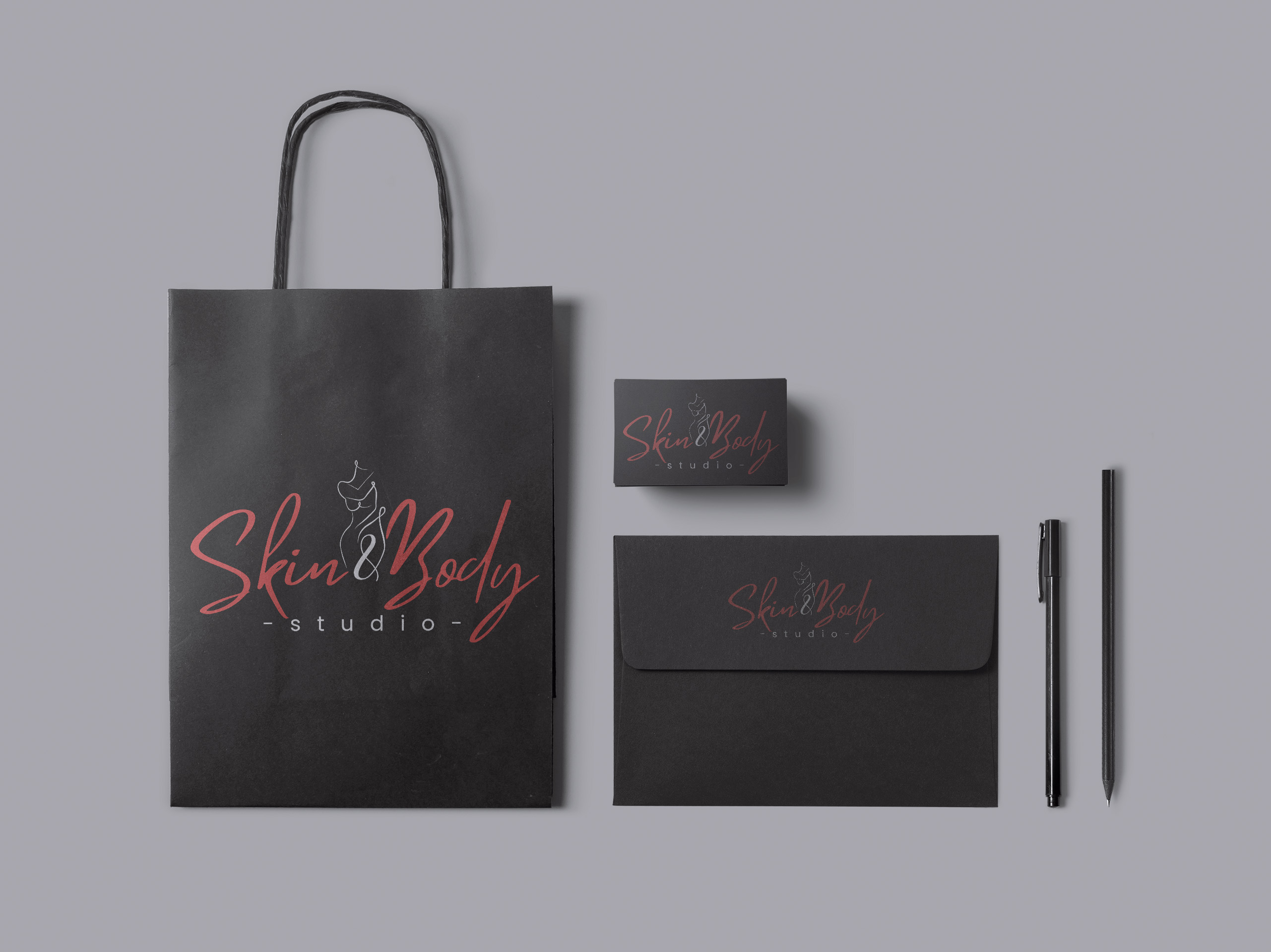 Dark bag, envelope and stationery concept carrying the Skin and Body Studio identity